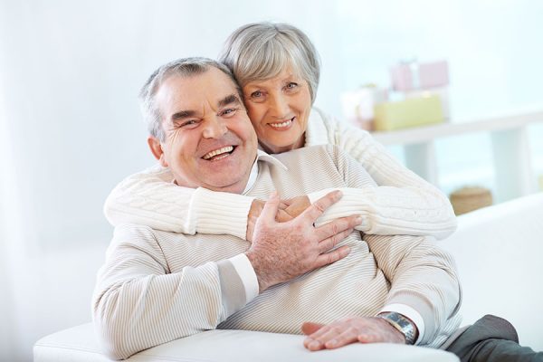 senior-couple-hugging-home